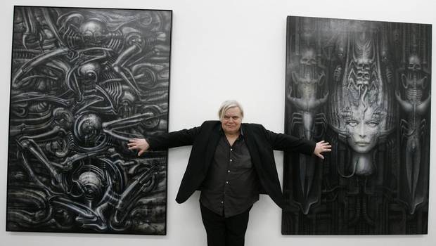 In this June 29, 2007 picture Swiss artist H.R. Giger poses with two of his works at the art museum in Chur, Switzerland. (Arno Balzarini/AP)
In this June 29, 2007 picture Swiss artist H.R. Giger poses with two of his works at the art museum in Chur, Switzerland. (Arno Balzarini/AP)