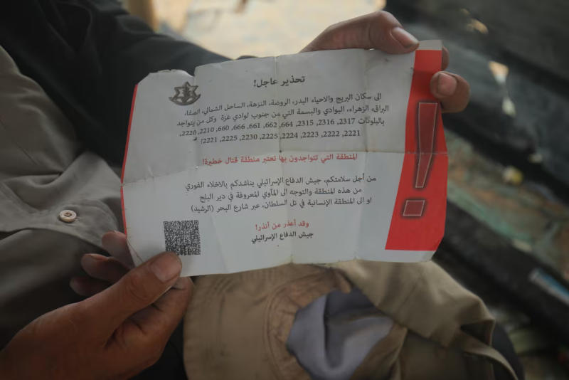 Go here. It's safe. -- An Israeli leaflet dropped in Rafah. The latter half reads as follows: 'For your safety, the Israeli Defence Force is asking you to leave these areas immediately and to go to known shelters in Deir el Balah or the humanitarian area in Tel al-Sultan through Beach Road. And don't blame us after we warned you.' (Mohamed El Saife/CBC) Go here. It's safe. -- An Israeli leaflet dropped in Rafah. The latter half reads as follows: 'For your safety, the Israeli Defence Force is asking you to leave these areas immediately and to go to known shelters in Deir el Balah or the humanitarian area in Tel al-Sultan through Beach Road. And don't blame us after we warned you.' (Mohamed El Saife/CBC)